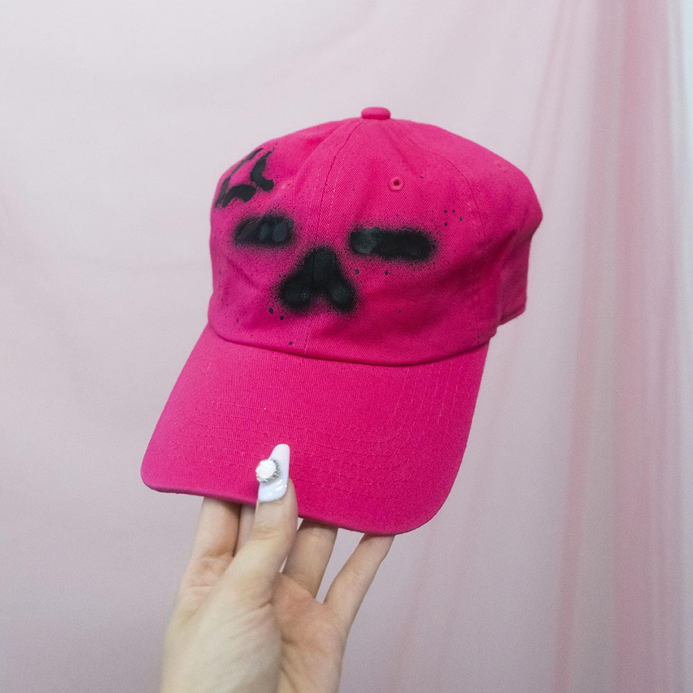 Spray painted "Annoyed kitty face" pink hat